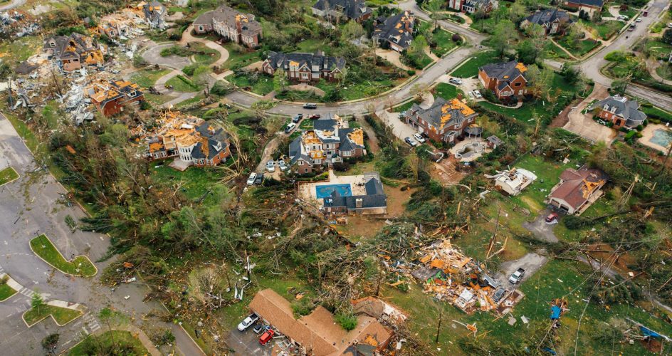 Aerial view of small settlement with destroyed houses and bent uprooted trees after hurricane