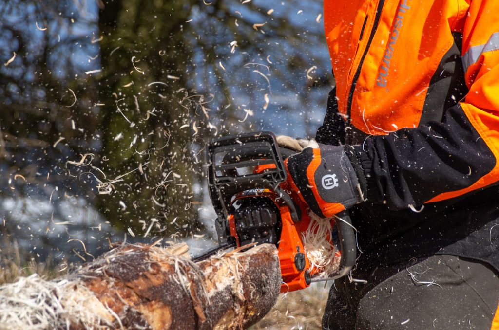 Close-up of a chainsaw cutting through a log